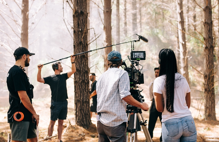 Crew of people filming in a forest