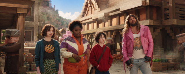 A still from A Minecraft Movie of the main cast standing in the middle of a village